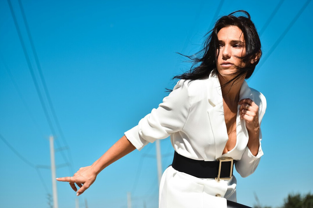 Smiling businesswoman with long dark hair in a blazer